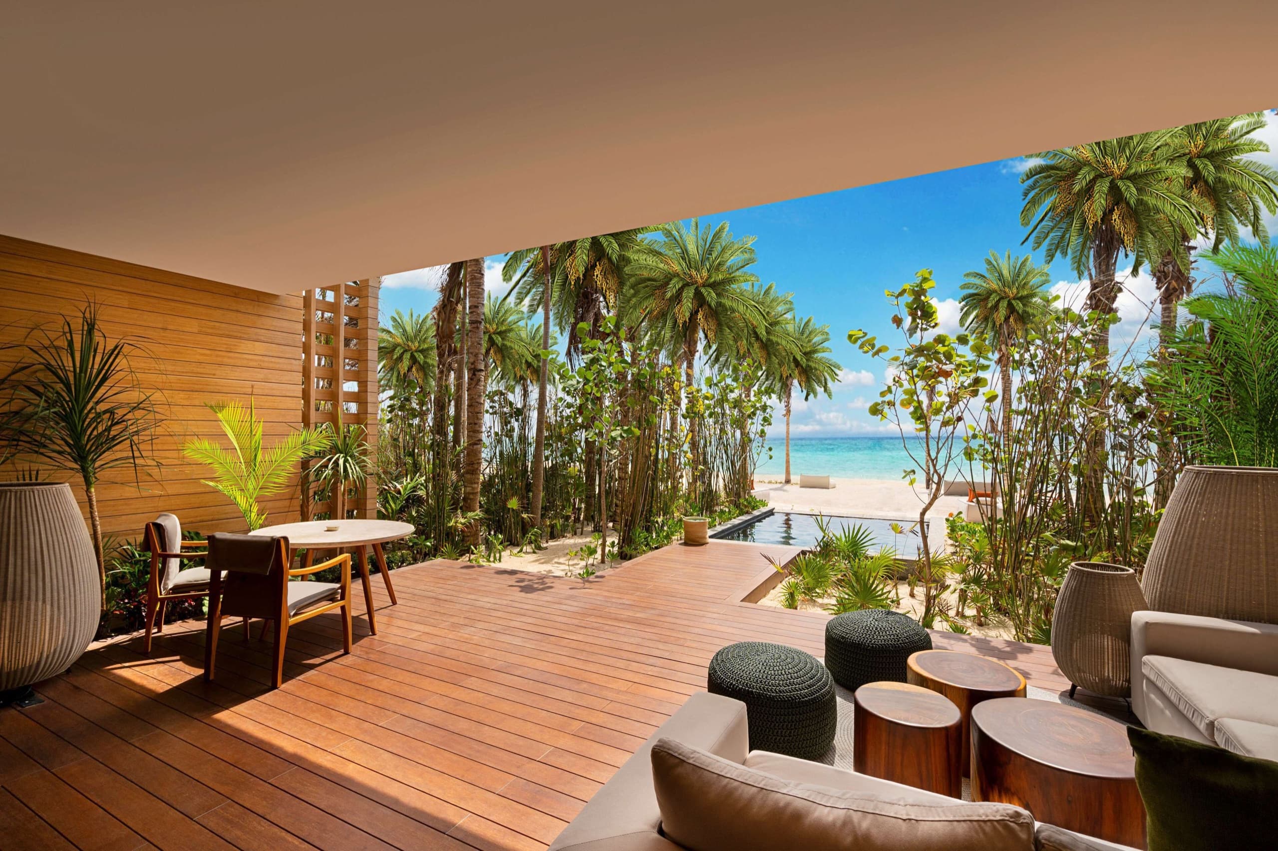 Palm-lined beachfront pool and terrace at Banyan Tree Mayakoba resort on Mexico's Riviera Maya